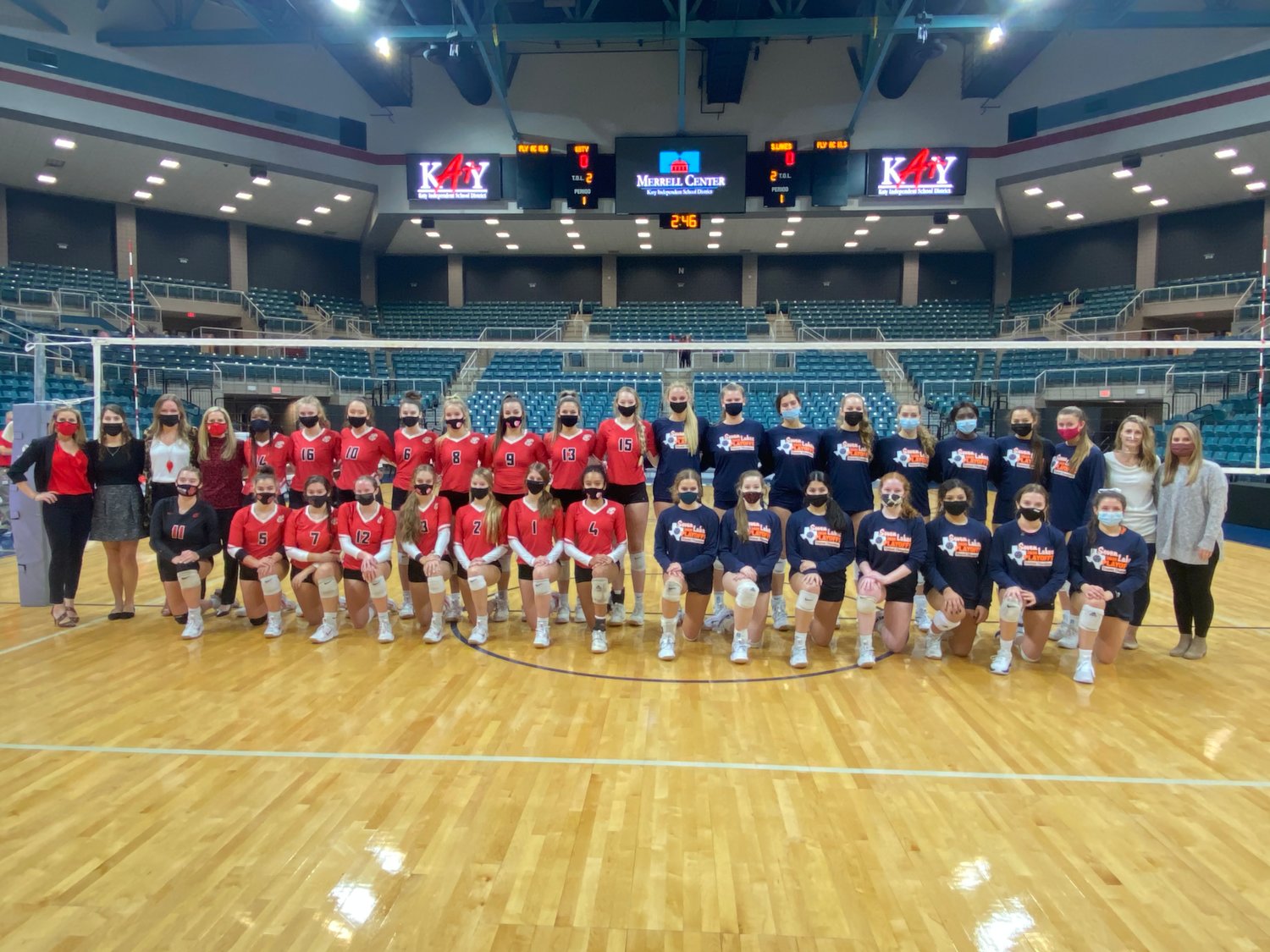 Katy High and Seven Lakes players and coaches posed for a photo before their Class 6A Region III volleyball final at the Merrell Center on Dec. 4. It was the first all-Katy ISD regional final in volleyball.